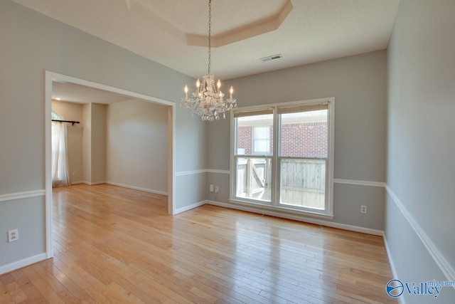 1102 Chesterfield Dr SE, Huntsville, AL 35803 - empty room with light wood-style flooring, a chandelier, and baseboards