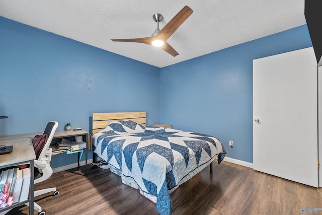 bedroom featuring baseboards, a textured ceiling, ceiling fan, and wood finished floors