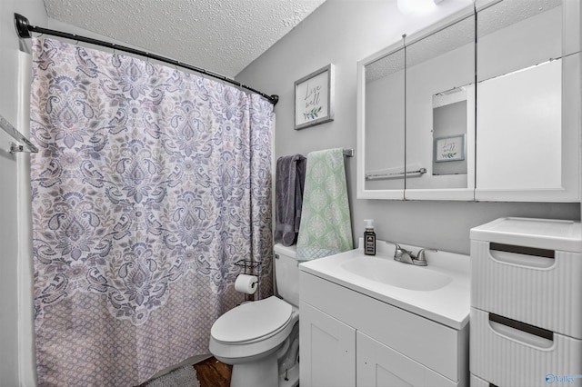 bathroom with a textured ceiling, wood finished floors, vanity, toilet, and a shower with shower curtain
