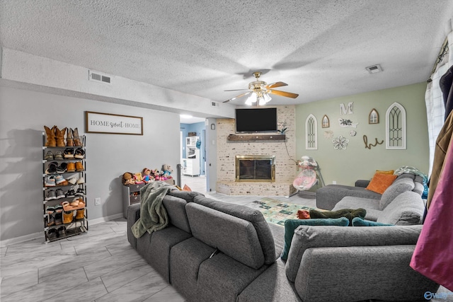 living area with ceiling fan, visible vents, marble finish floor, and a fireplace