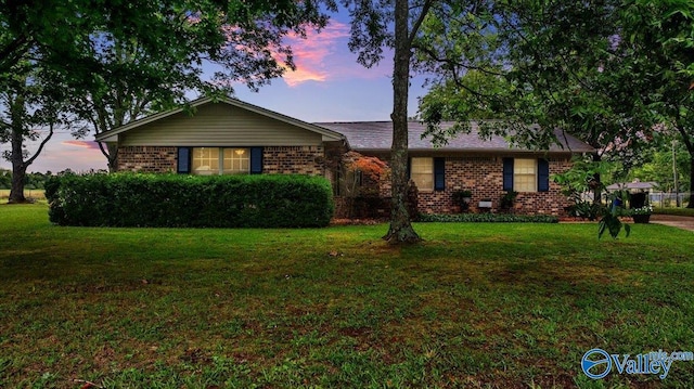 ranch-style house featuring a lawn