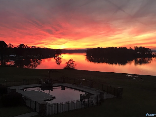 pool at dusk with a water view