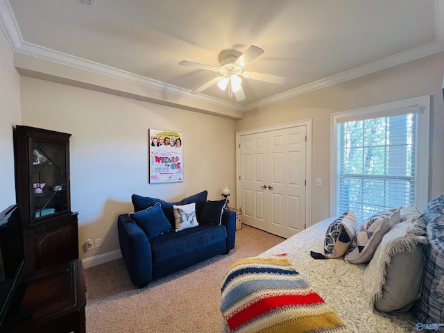 bedroom featuring crown molding, ceiling fan, a closet, and carpet