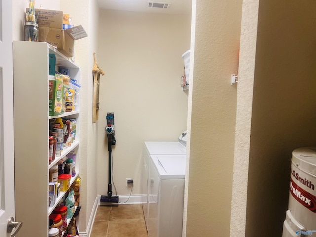 washroom featuring separate washer and dryer and light tile patterned floors