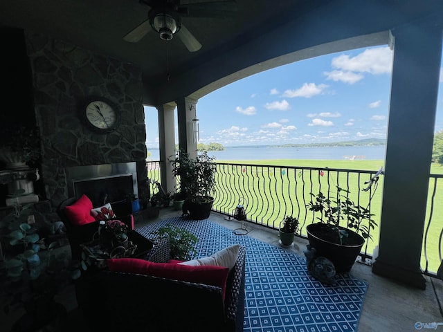 balcony with a water view and ceiling fan