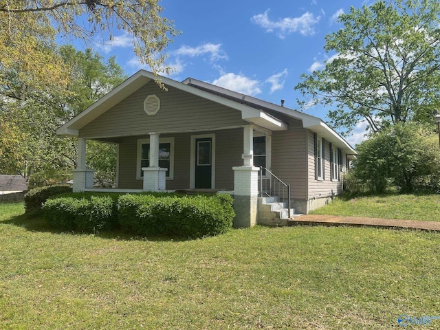 bungalow featuring a porch and a front lawn
