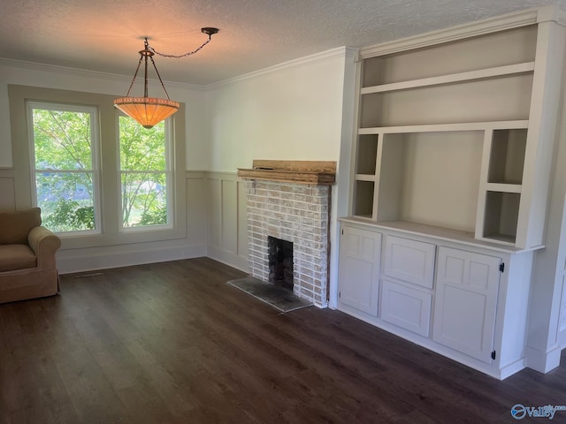 unfurnished living room featuring a fireplace, crown molding, dark wood-style flooring, and wainscoting