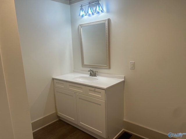 bathroom featuring baseboards, vanity, and wood finished floors