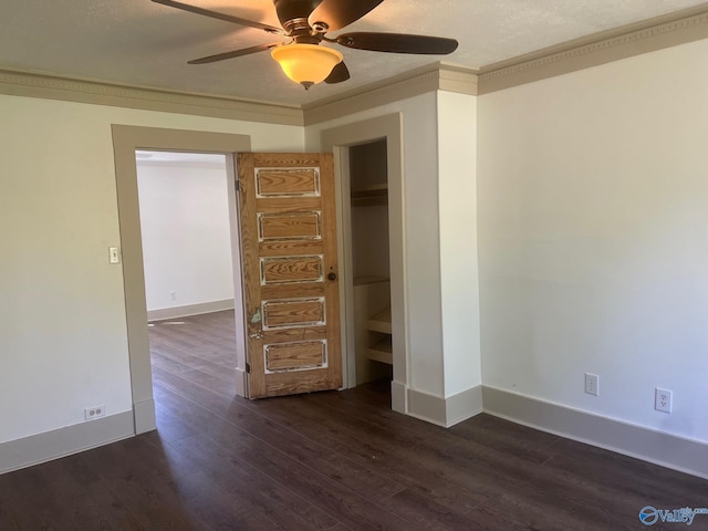 unfurnished bedroom featuring ceiling fan, baseboards, crown molding, and dark wood-style floors