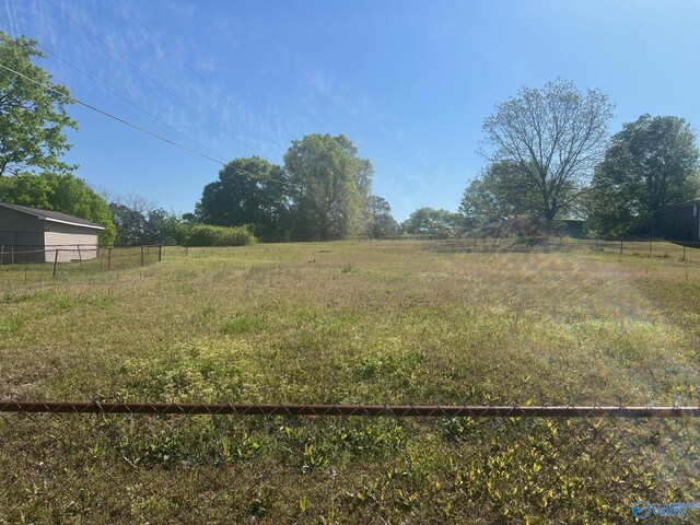 view of yard with a rural view and fence