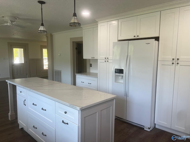 kitchen with white cabinets, white refrigerator with ice dispenser, pendant lighting, and dark wood finished floors