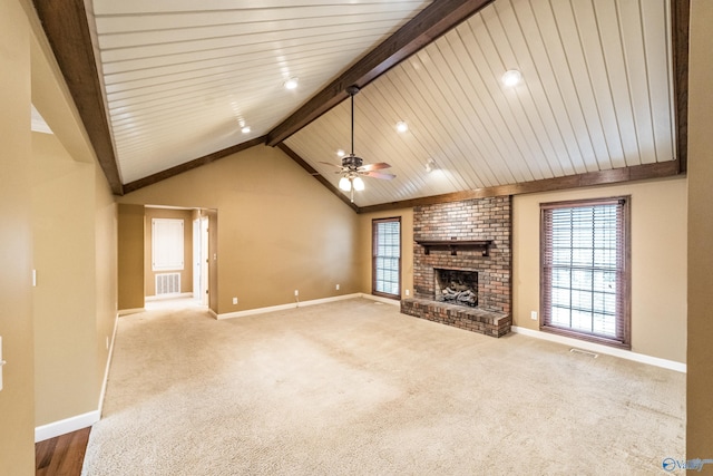 unfurnished living room featuring carpet floors, vaulted ceiling with beams, ceiling fan, and a fireplace