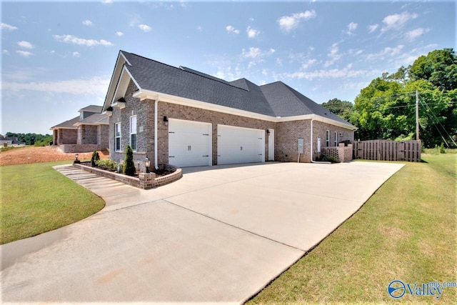 view of front of house featuring a garage and a front yard