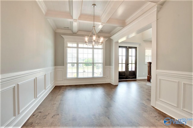 unfurnished dining area featuring crown molding, dark hardwood / wood-style flooring, a notable chandelier, and beam ceiling