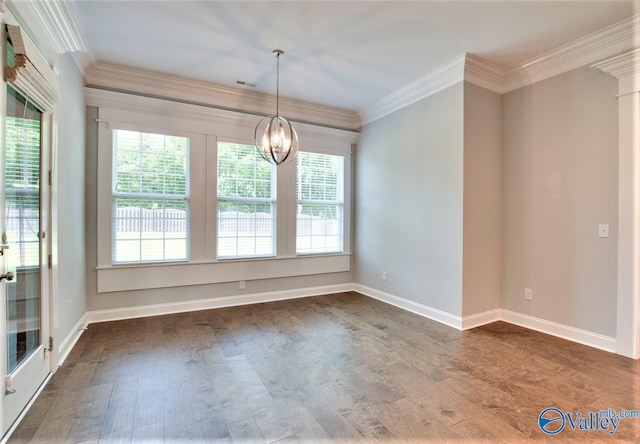 unfurnished dining area with crown molding, dark hardwood / wood-style flooring, and a notable chandelier