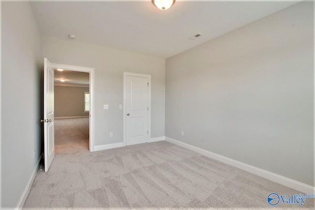 unfurnished bedroom with light colored carpet