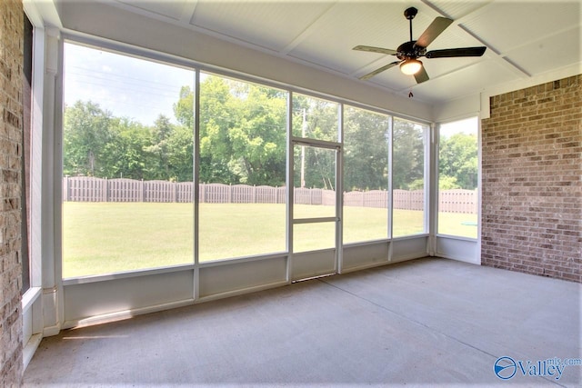 unfurnished sunroom featuring ceiling fan