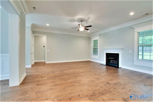 unfurnished living room featuring light wood-type flooring, ceiling fan, and ornamental molding