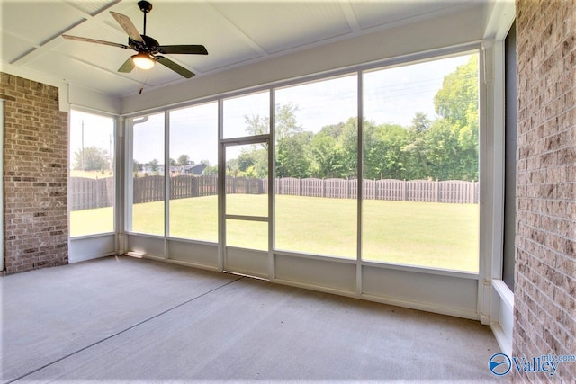 unfurnished sunroom with ceiling fan