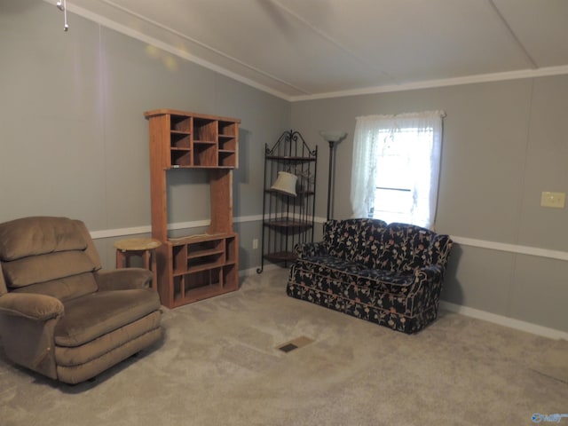 living area featuring ornamental molding and carpet