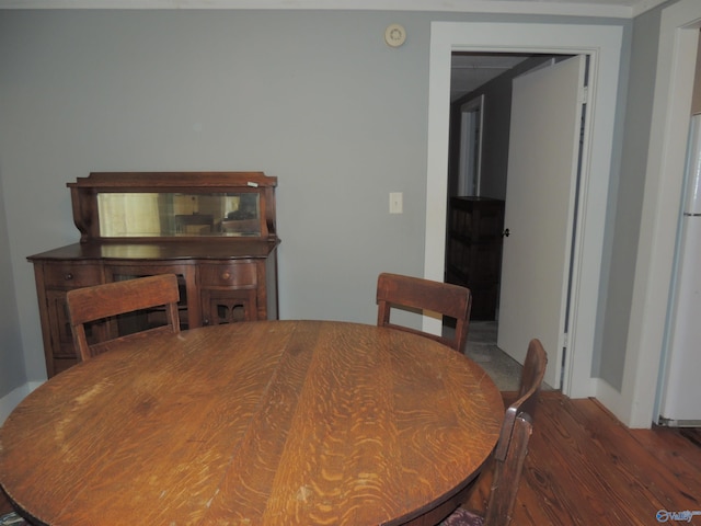 dining space with hardwood / wood-style floors