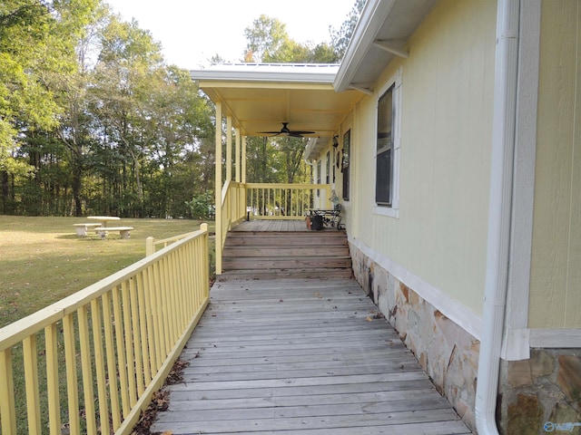 wooden deck with a yard and ceiling fan