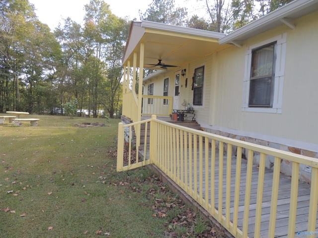 view of yard featuring a wooden deck and ceiling fan