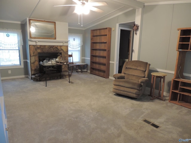 living room with ornamental molding, light colored carpet, a fireplace, and vaulted ceiling