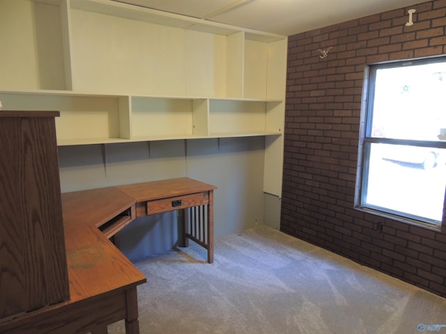 office area featuring brick wall, carpet, and a wealth of natural light