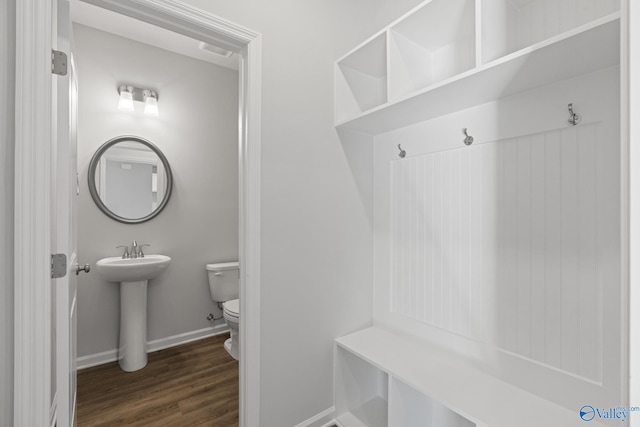 mudroom with sink and dark hardwood / wood-style flooring