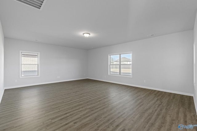 spare room featuring dark hardwood / wood-style flooring