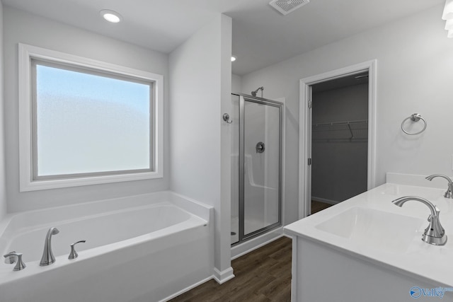 bathroom with vanity, wood-type flooring, and shower with separate bathtub