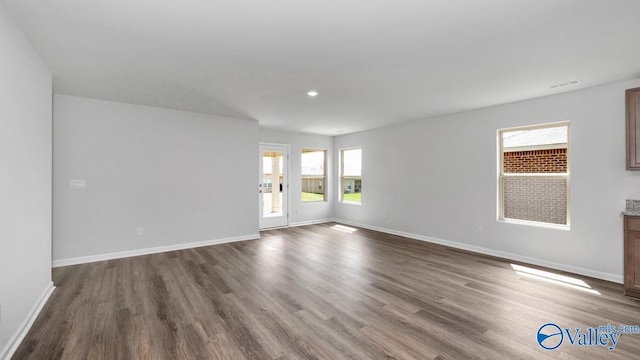 spare room featuring dark hardwood / wood-style floors