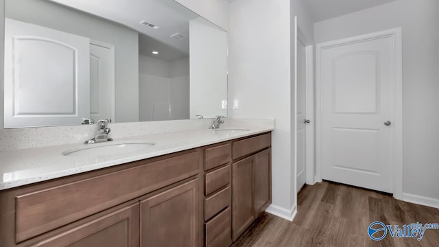 bathroom with vanity and hardwood / wood-style flooring