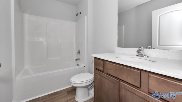 full bathroom featuring hardwood / wood-style flooring, vanity, toilet, and shower / bathing tub combination