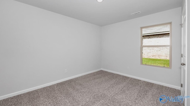 carpeted spare room featuring plenty of natural light