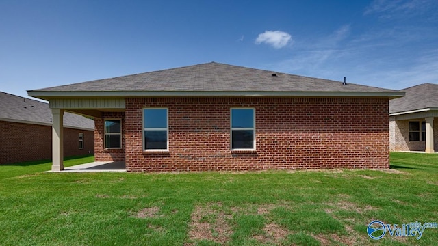 rear view of house featuring a lawn and a patio area