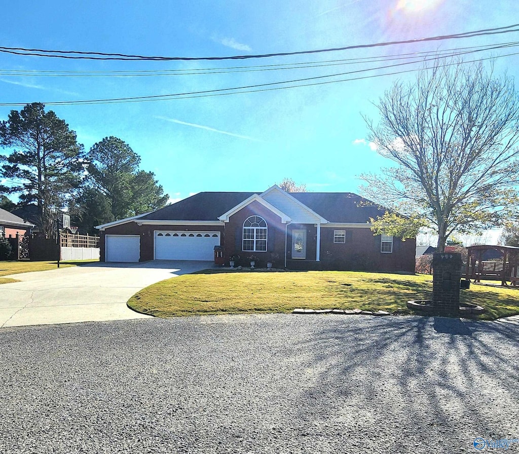 ranch-style home with a front yard and a garage