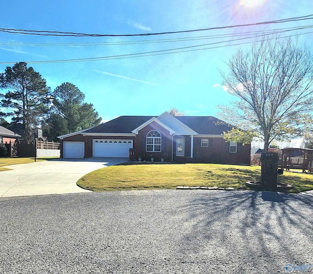 ranch-style home with a front yard and a garage