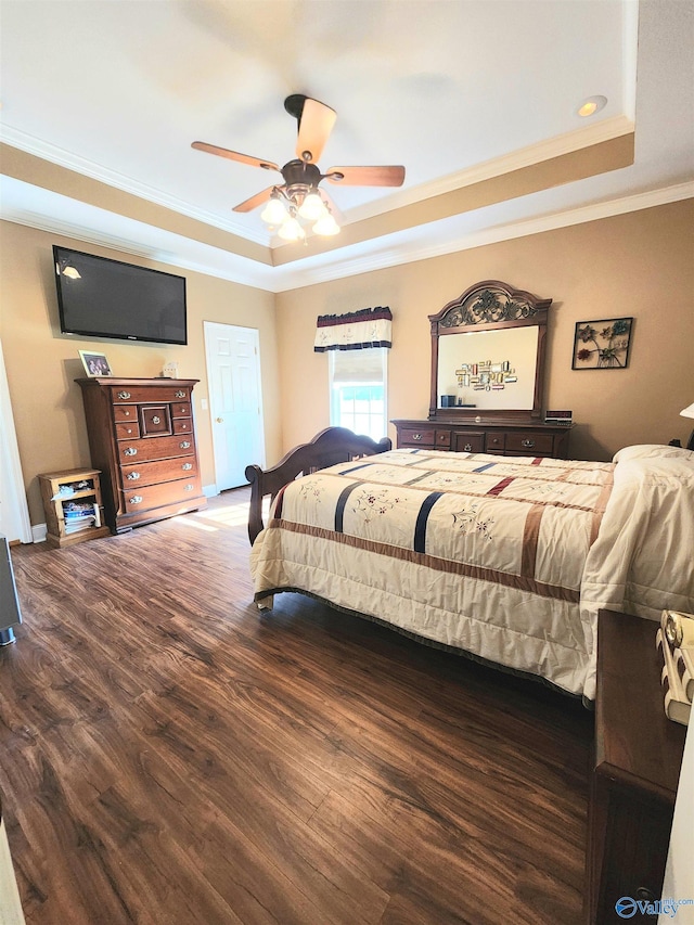 bedroom with a raised ceiling, ceiling fan, hardwood / wood-style floors, and crown molding