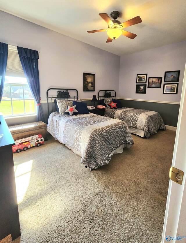 carpeted bedroom featuring ceiling fan