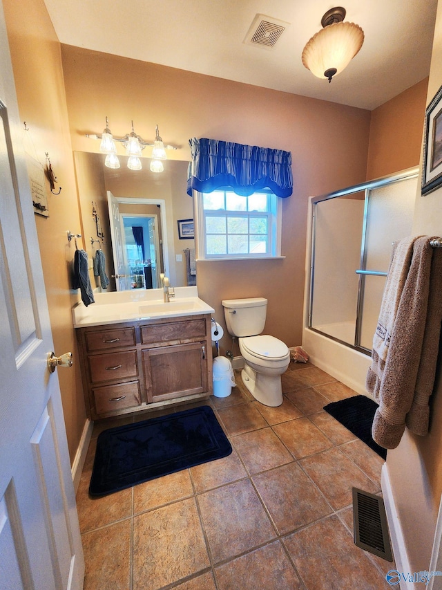 full bathroom featuring tile patterned flooring, vanity, toilet, and shower / bath combination with glass door