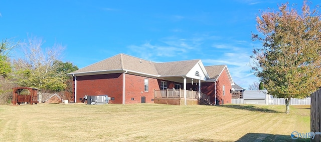 view of side of home featuring a lawn and cooling unit