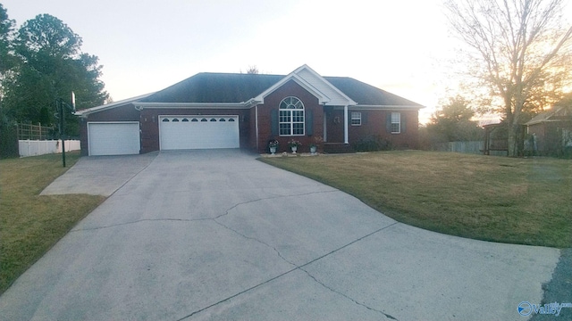 ranch-style home with a garage and a yard