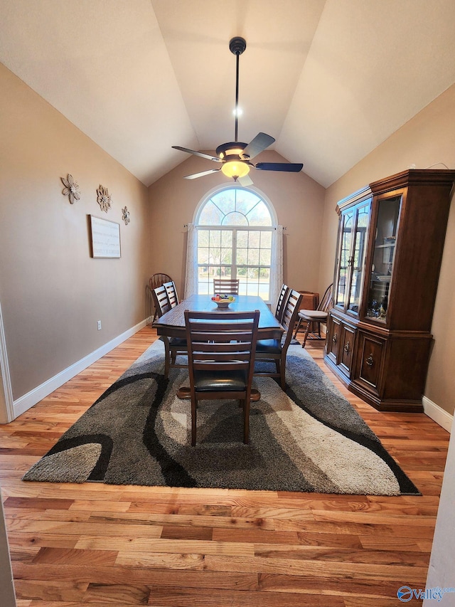 dining room with ceiling fan, light hardwood / wood-style flooring, and lofted ceiling