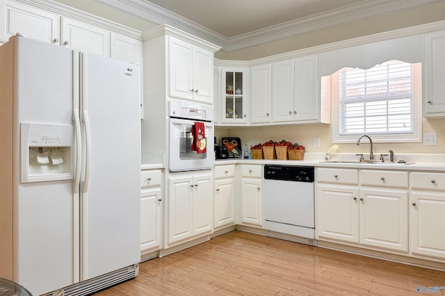 kitchen featuring white appliances, white cabinetry, crown molding, and sink