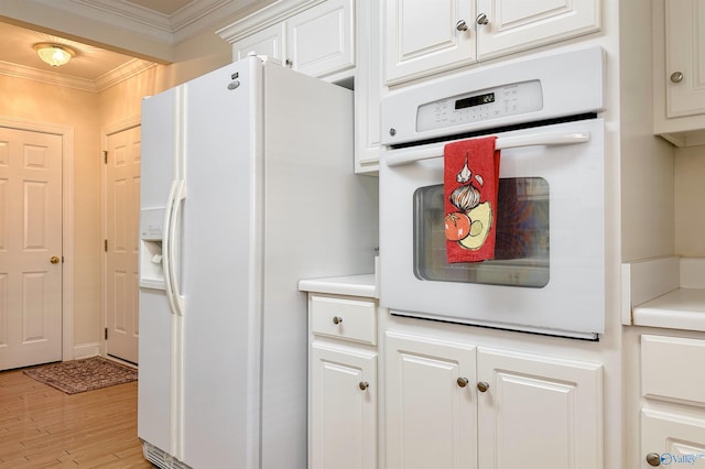 kitchen with light hardwood / wood-style floors, white cabinetry, white appliances, and ornamental molding