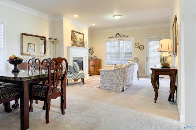 dining area with light carpet and ornamental molding