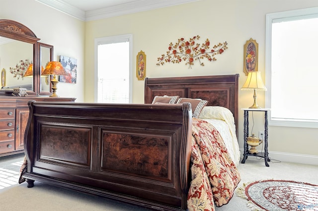 bedroom featuring crown molding and light carpet