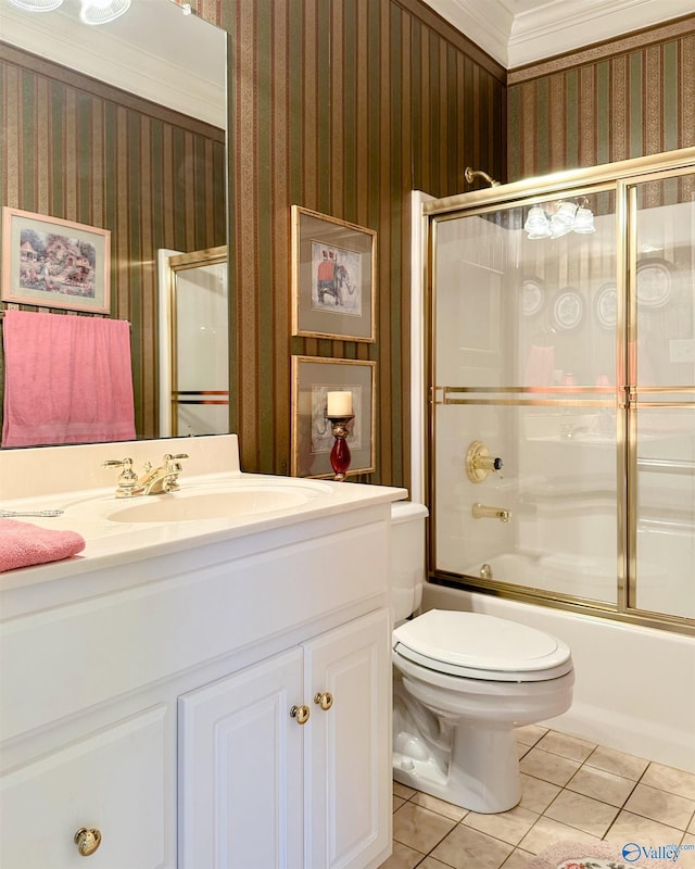 full bathroom featuring vanity, crown molding, enclosed tub / shower combo, tile patterned flooring, and toilet